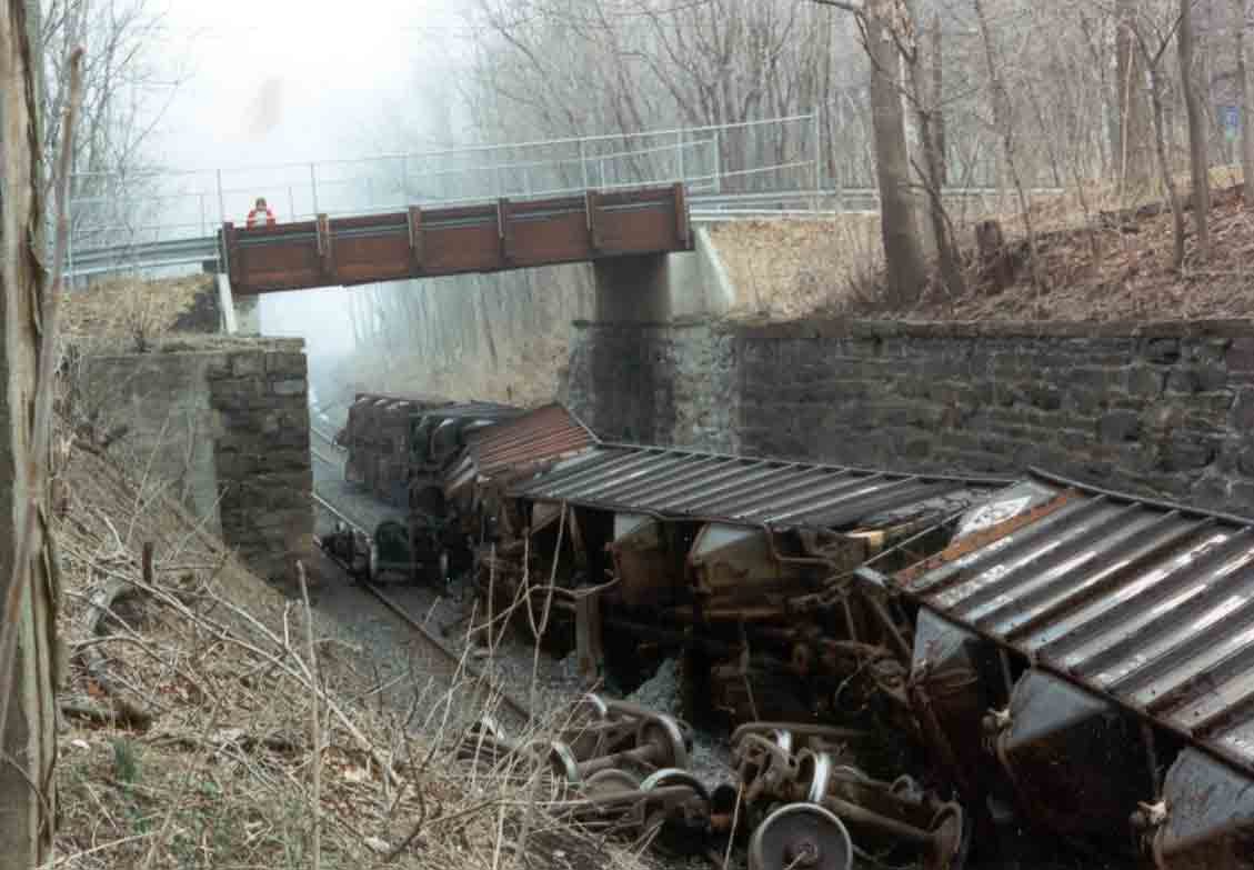 Freight cars derailed in the stone-walled Barrytown railroad cut, winter